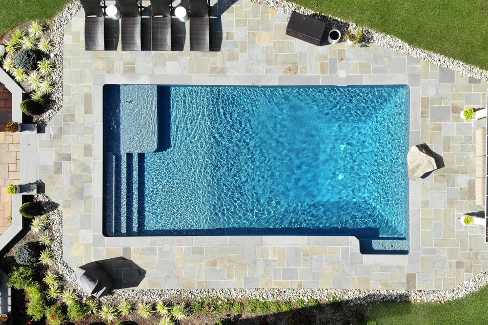Luxury residential swimming pool and bluestone patio inspected by Aquatic Pool Inspections in New Jersey